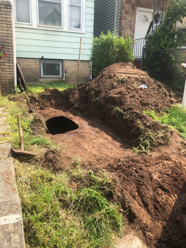 Wegman Parkway, Jersey City: front-yard excavation exposing the 1,000-gallon tank